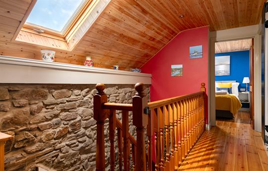 Landing with exposed stone wall and babygate