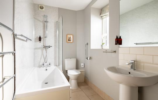 Bathroom with a shower over the bath