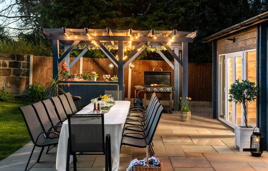 Outdoor kitchen area, bar and seating for 14