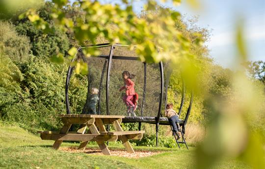 Trampoline in play area with children