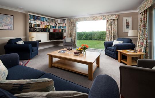 Large sitting room with woodburning stove.