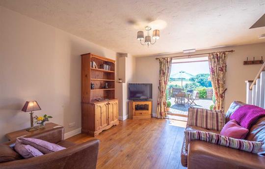 Lounge area with doors leading out to the patio