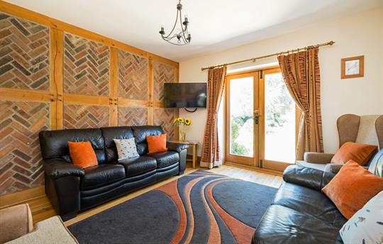 Cosy sitting room with doors to patio & garden