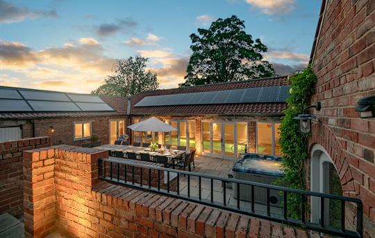 Evening photo of the hot tub, pool room and table