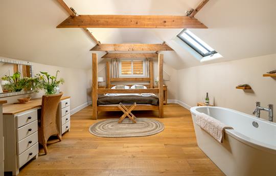 Master bedroom upstairs with 4 poster bed and bath