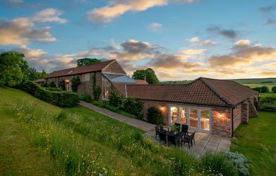 Dusk view of the pool room from wildflower area 