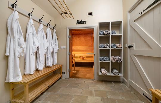 Sauna with pool robes and towels at Marris Barn