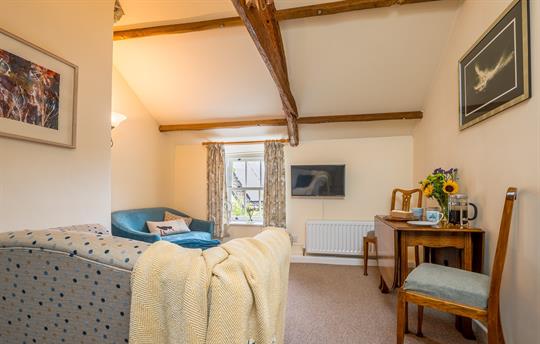 Open-plan lounge with fully equipped kitchen