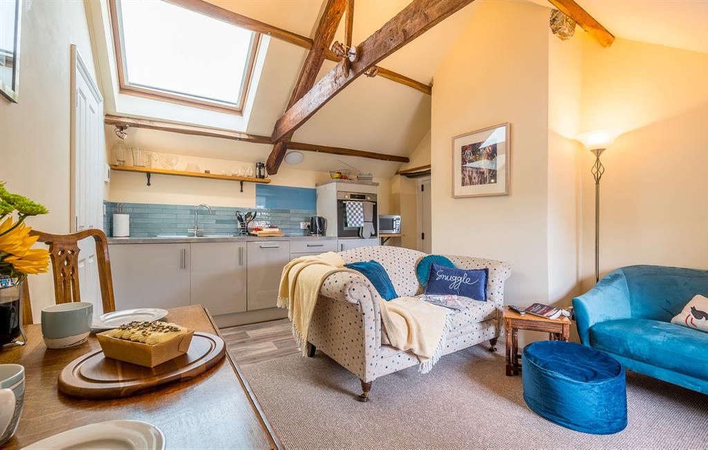 Open-plan lounge with fully equipped kitchen