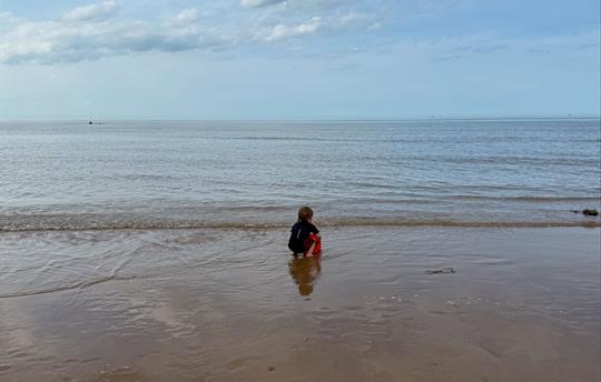 Our son playing on the beach