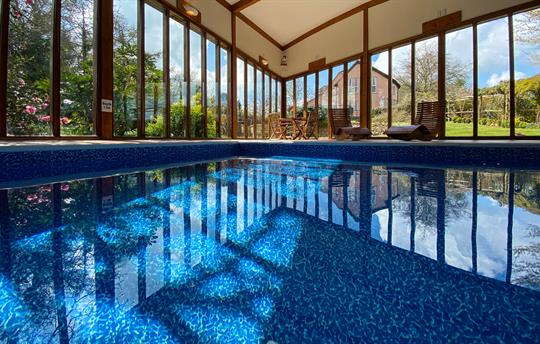 Large swimming pool with views across the lawn.
