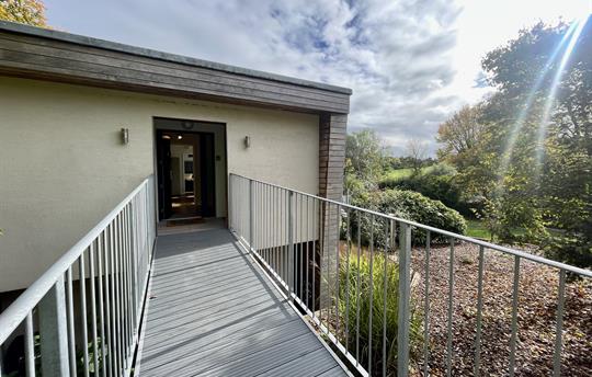 Level entrance from the parking area at The Nest