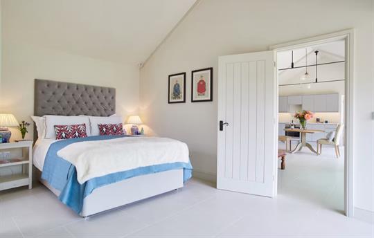 Spacious bedroom with view to the sitting room