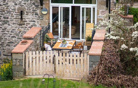 Haystore patio area leading to shared garden