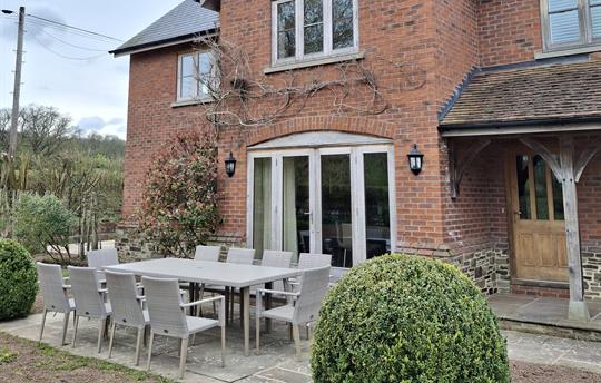 Patio by kitchen French door with garden furniture