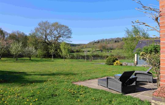 View Across back garden, large lawn and patio