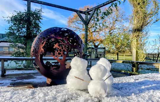 Sunny winters day - snowmen by the fireball