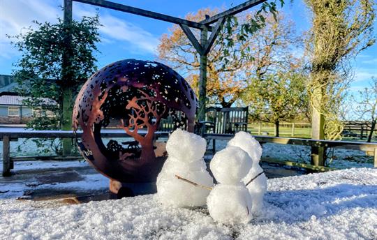 Sunny winters day - snowmen by the fireball