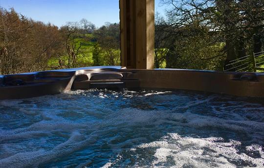 Private hot tub overlooking the river below