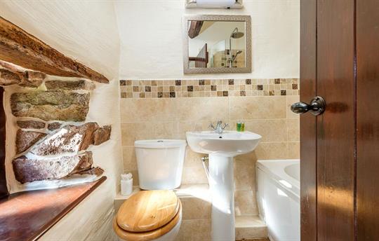 Bathroom with 500 year old exposed pink granite